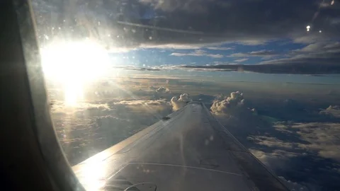 Viewing the clouds and sunset from an plane window Stock Footage 117370114