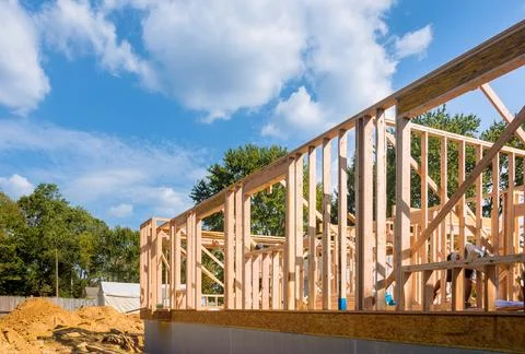 Viewing construction work in progress on an unfinished house with wooden framing Stock Photos