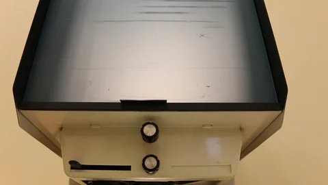 Viewing document slides on microfilm device display 스톡 동영상 99191047