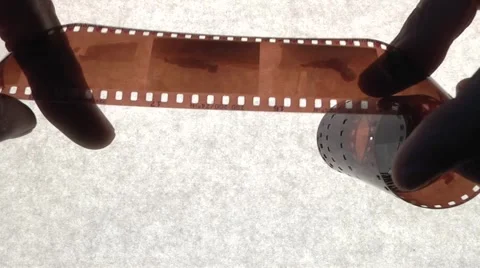 Viewing the film in the hands of Stock Footage 1079408