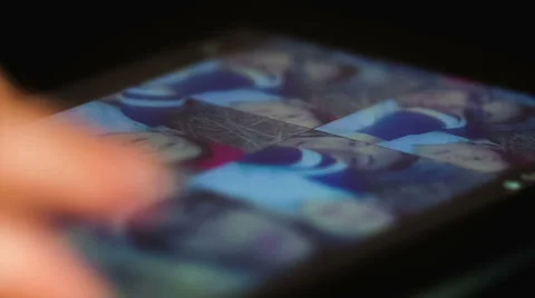 Viewing images on a touchscreen in the dark Stock Footage 48064126