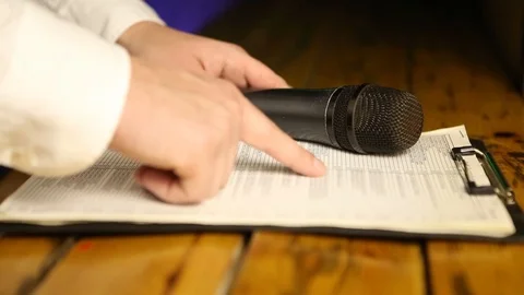 Viewing a list,  microphone Stock Footage 99932524