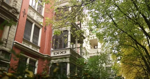 Viewing a old red german building in nice area surrounded by autumn trees, 4k Stock Footage 230488537