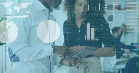 Viewing pair with tablet in tech office with data overlays, world map, wearing Stock Photos