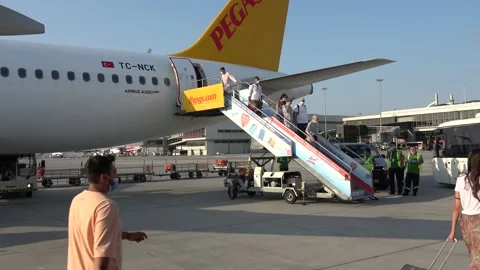 Viewing passengers leaving their plane in the airport Stock Footage 158468413
