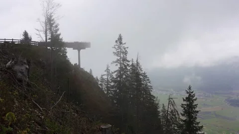 A viewing platform partly obscured by low cloud in a valley in the Stock Footage 143228753