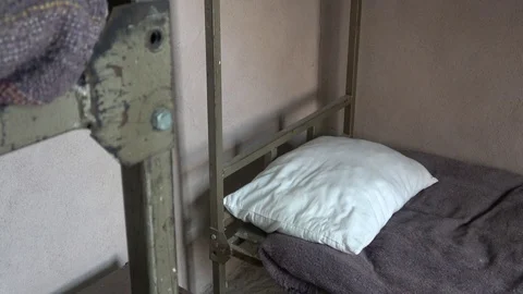 Viewing prison bed with pillow and blanket Stock Footage 115539652