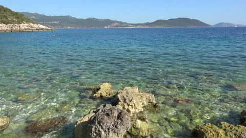 Viewing the skyline and then rocks in the water Stock Footage 166194155