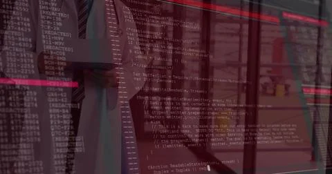 Viewing suited professional analyzing reflected code on glass wall in office 写真素材