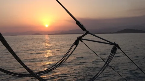 Viewing sunset behind rigging from a boat on the go Video stock 112281444