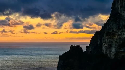 Viewing the sunset next to a sharp cliff at the Mediterranean sea at Amalfi.. Stock Photos