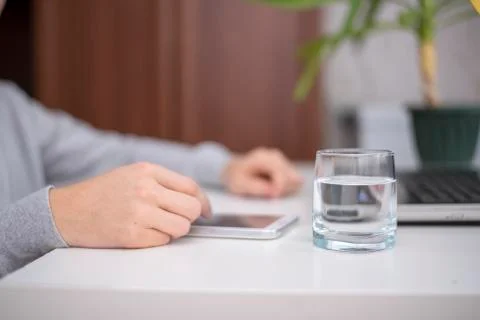 Viewing a tablet while sitting at white table Foto stock
