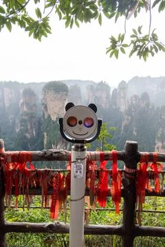 Viewing telescope featuring a smiling face design positioned at a scenic view Stock Photos