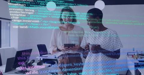 Viewing two women using tablet in office with code overlay, holding mug in work Stock Photos