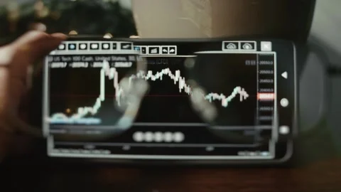 Viewing US Tech 100 Price Chart on a crypto trading platform on smartphone Stock Footage 291451334