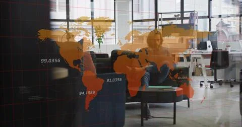 Viewing world map overlay on smartphone by man on sofa in office lounge, with Stock Photos