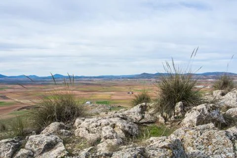 A viewpoint at the hill with a view to fields and mountains near Consuegra .. Stock Photos