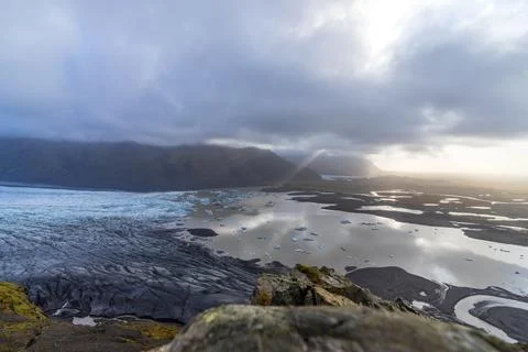 Viewpoint to a massive glacier with clouds and ray lights Photos