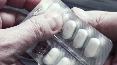 Viewpoint of the person taking the pill from the package. 스톡 동영상 203821709