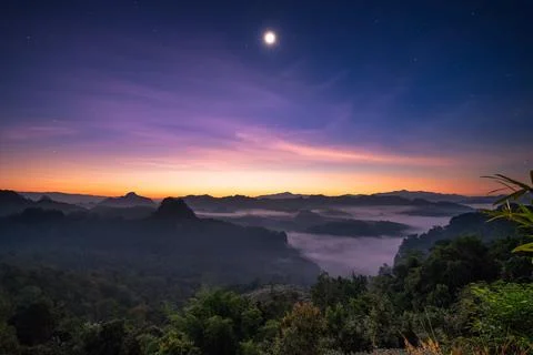 Viewpoint sunlight over mountain with the moon at dawn Stock Photos