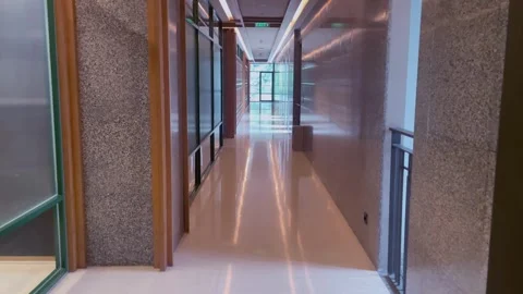 The viewpoint is walking through a corridor with shiny, reflective floors. Stock Footage 320500938