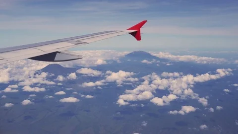 Viewpoint Wing of windows airplane flying above the clouds in the sky Stock Footage 77206129
