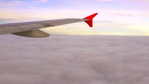 Viewpoint Wing of windows airplane flying above the clouds in the sky Stock Footage 77206142