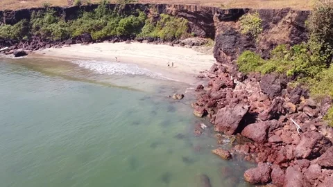 Views from above, camera flying over the sea and a beautiful wild beach. Video stock 228685144