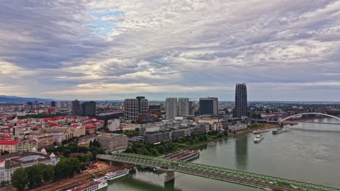 Views of a city skyline with clouds over a river and a bridge during the Stock Footage 340943962