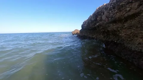Views of a drone flying off cliffs in the middle of the mediterranean sea Stock Footage 164867575
