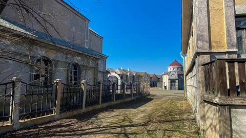 Views of an old abandoned building complex with a clear blue sky in the bac.. Stock Photos