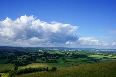 Views over countryside farm fields with clouds in blue sky in the summer 写真素材