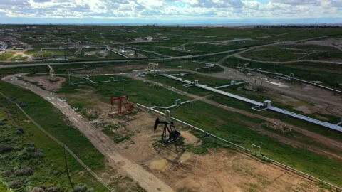 Views of petroleum extraction plants surrounded by overcast weather conditions Stock Footage 342950953