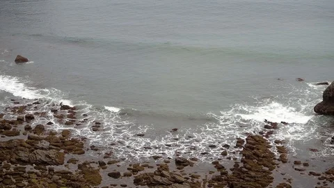 Views of a rocky beach on a cloudy day Stock Footage 107434786