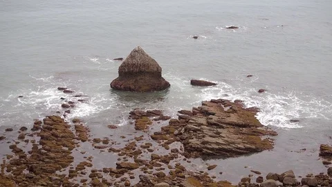Views of a rocky beach on a cloudy day Stock Footage 107434793
