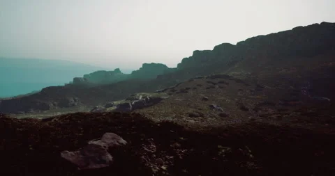 Views of rocky landscape under a hazy sky at twilight in mountainous region Stock Footage 315693689