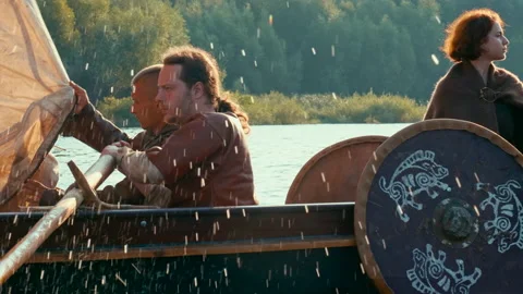 A Viking Dressed in Armor is on Board an Old Ship Sailing Along the River. Stock Footage 163924468