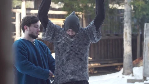 Viking getting mail armor on, in slow-mo flat image Stockbeeldmateriaal 89121524
