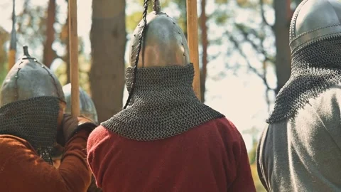 Viking men dressed in armor participate in training while surrounded by trees. 库存影片 345029829