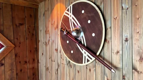Viking Shield and Sword Displayed on Wooden Wall in Traditional Norwegian Stock Footage 340121939