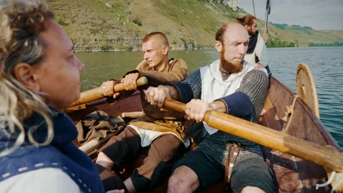 Vikings Row on Drakkar in the Middle of the River Medieval Reconstruction. Stock Footage 156555661