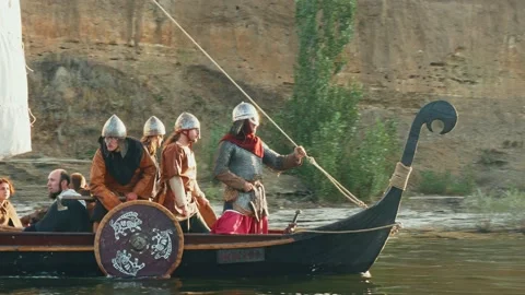 Vikings Stand Aboard the Drakkar, Dressed in Armor. Vikings Sail on an Old Ship Stock Footage 163963557