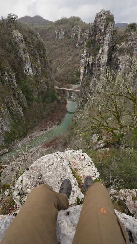 Vikos Gorge cliffs with river and stone bridge below Epirus Greece Stock Footage 332619928