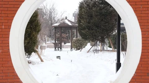 A villa courtyard in the falling snow Stock Footage 345872430