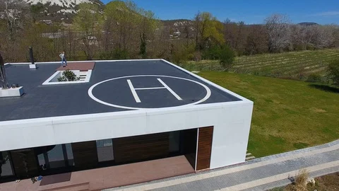 Villa with pool in mountains. Man doing workout on roof of house. Aerial view 스톡 동영상 129792784