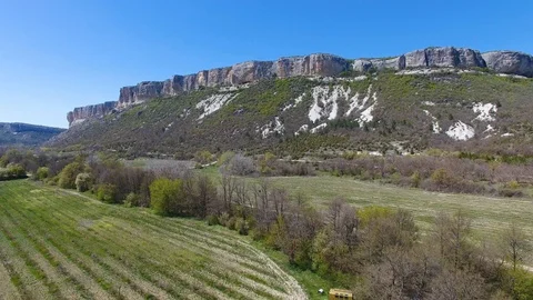 Villa with pool in mountains. Man doing workout on helipad on roof. Aerial view Stock Footage 129792824