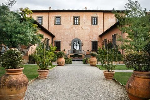 Villa with rows of large pots with trees and flowers Stock Photos