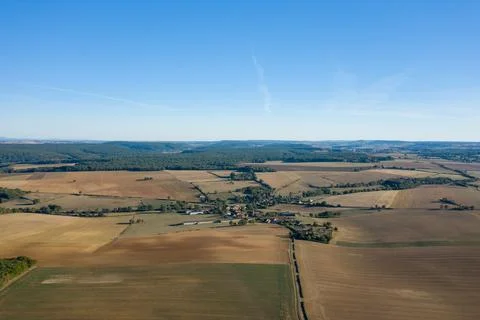 Village and patchwork fields under blue sky 스톡 사진