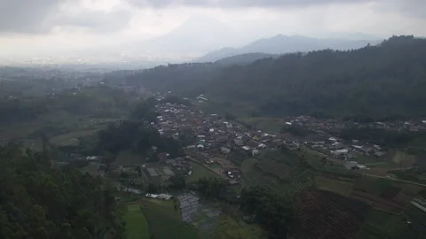Village and rice fields in cloudy mountain area next in 4K, Indonesia Stock Footage 200873096