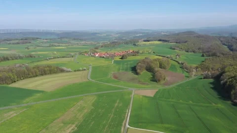 The village of Archfeld between the fields in North Hesse Stock Footage 240645615